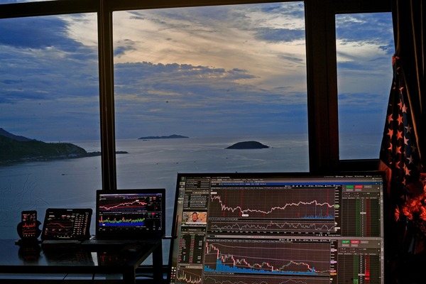 Multiple monitors displaying live cryptocurrency trading charts
