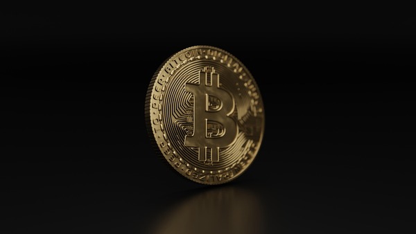 Gold Bitcoin coin on a dark background